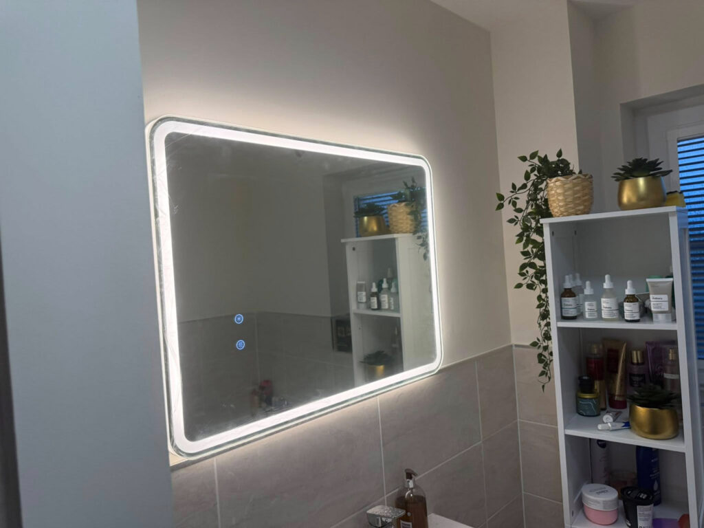 Modern LED bathroom mirror installation with hidden wiring in Stirling
